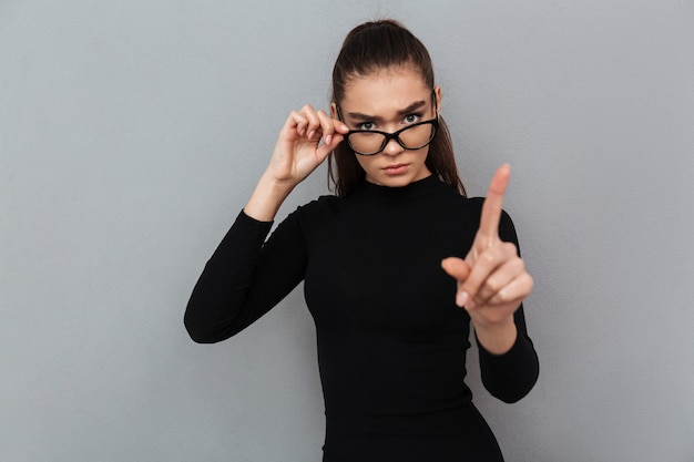 Photo gratuite portrait d'une jolie femme sérieuse en robe noire