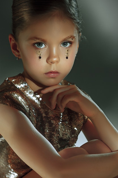 Le portrait de mode de la belle jeune adolescente au studio