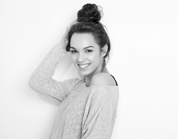 Photo gratuite portrait de modèle de jeune fille belle jeune femme brune avec du maquillage nue dans des vêtements d'été posant près du mur.