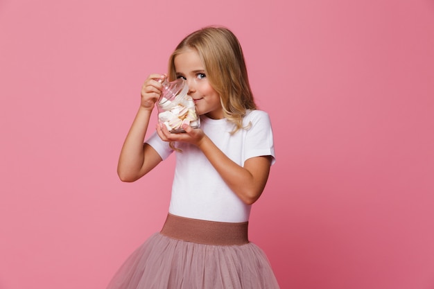 Portrait d'une petite fille souriante sentant la guimauve