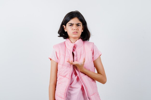 Portrait d'une petite fille en t-shirt blanc et gilet matelassé