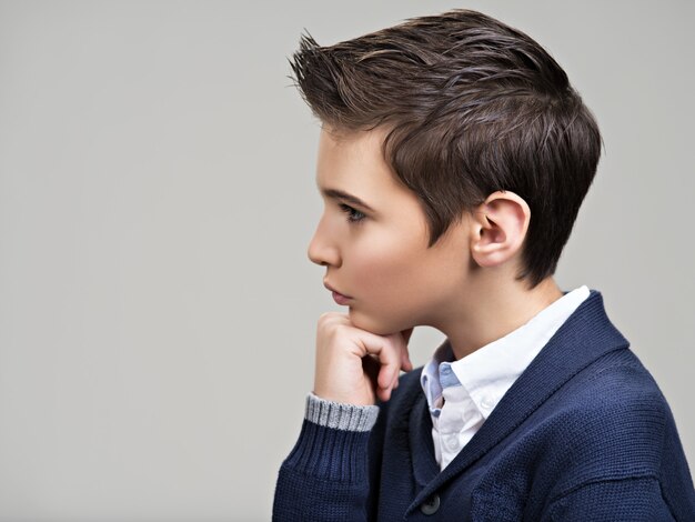 Portrait de profil d'un beau adolescent posant au studio comme mannequin.