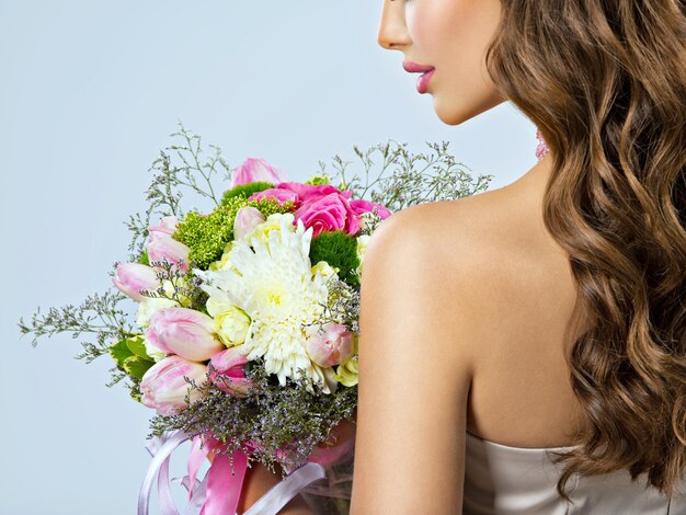 Portrait de profil d'une fille avec des fleurs dans les mains. Demi visage