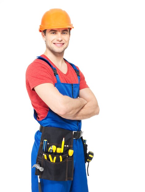 Portrait de souriant travailleur manuel avec des outils isolés sur blanc