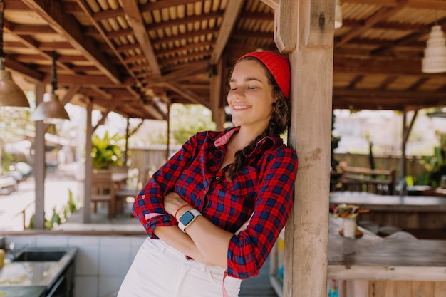 Portrait de style de vie à l'extérieur de l'heureuse femme détendue pose sur la terrasse d'été au soleil. De vraies émotions.