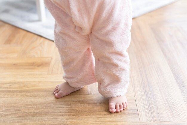 Les premiers pas de bébé avec de jolis petits pieds