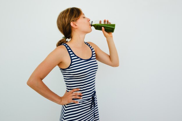 Pretty Young Woman Drinking Fresh Green Juice