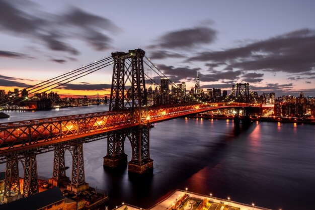 Prise de vue en grand angle d'un pont suspendu lumineux la nuit