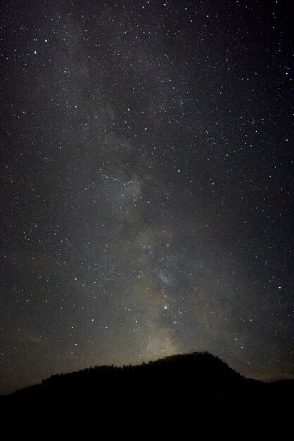 Prise de vue verticale d'une colline avec un paysage à couper le souffle de la galaxie de la Voie lactée