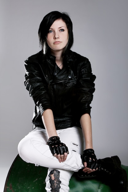 Punk Girl Sitting On Metal Barrel