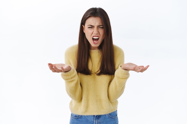 Photo gratuite qu'est-ce qui ne va pas. femme ayant un argument criant à la personne avec une expression en colère, indignée et frustrée, levant les mains avec consternation maudissant de rage