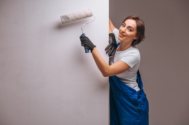 Réparateur de femme avec rouleau de peinture isolé