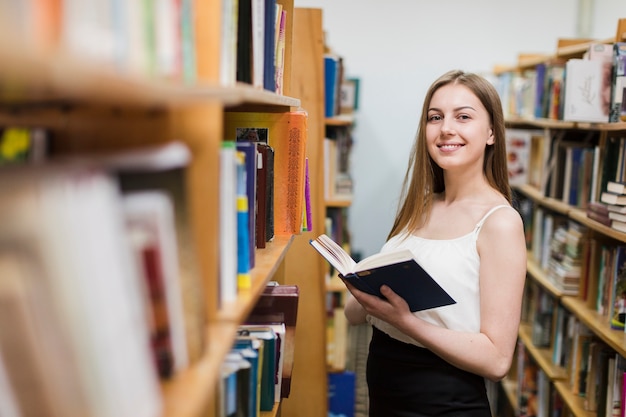 Retour au concept d&#39;école avec une femme étudiant en bibliothèque