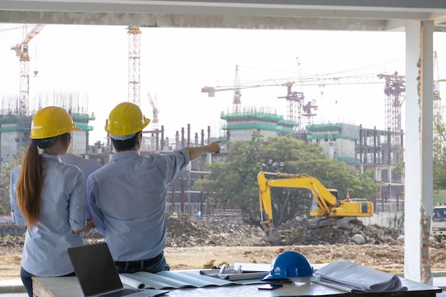 Photo gratuite réunion du groupe ingénieur et des travailleurs, discussion avec plan de construction sur site et point d'accès sur le site de travail