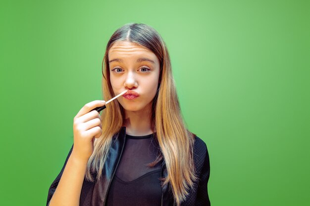 Rouge à lèvres. Petite fille rêvant de profession de maquilleur.