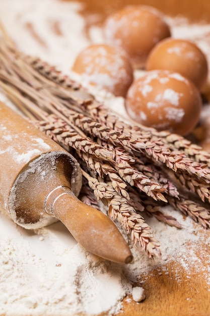 Photo gratuite rouleau à pâtisserie et œufs dans la farine