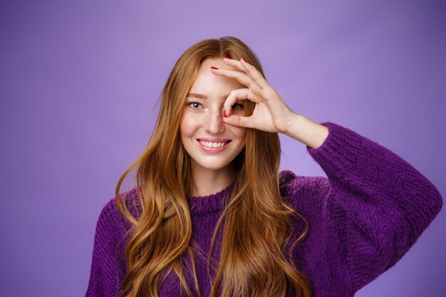 Rousse charismatique enjouée et insouciante avec des taches de rousseur et des cheveux longs montrant des signes corrects ou nuls ...