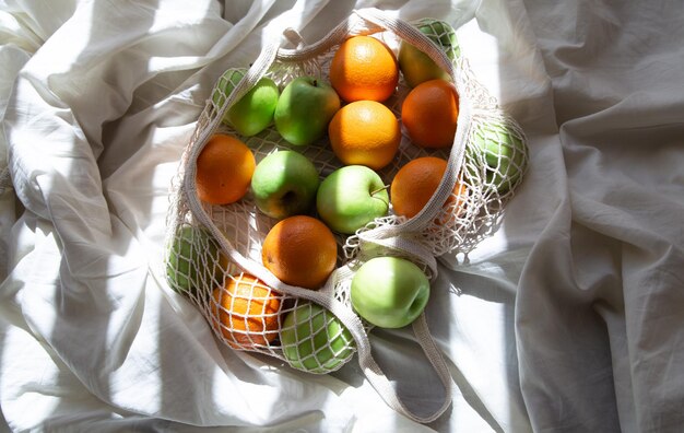 Sac à cordes avec des fruits au lit avec des rayons de soleil