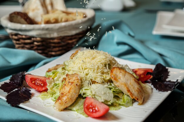 Salade César poulet laitue tomate citron parmesan anchois vue latérale
