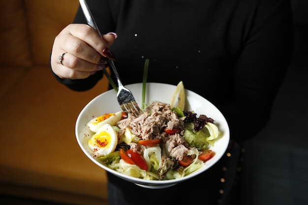 Salade César servie avec du thon sur le dessus