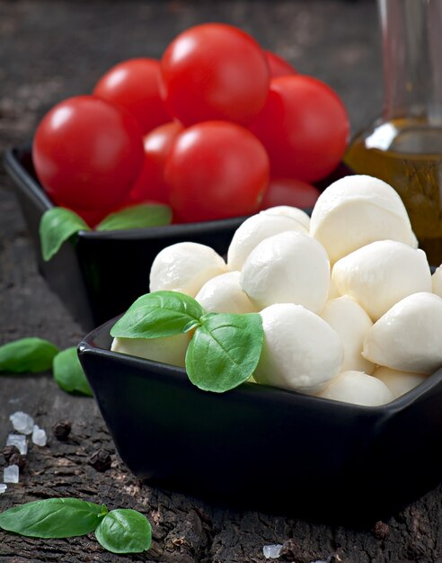 Salade fraîche aux tomates cerises, basilic, mozzarella et olives noires.