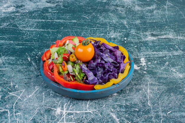 Salade verte avec laitue hachée, choux violets, piment et tomates.