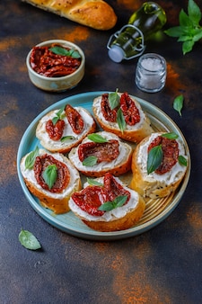 Sandwichs italiens - bruschetta au fromage, tomates séchées et basilic