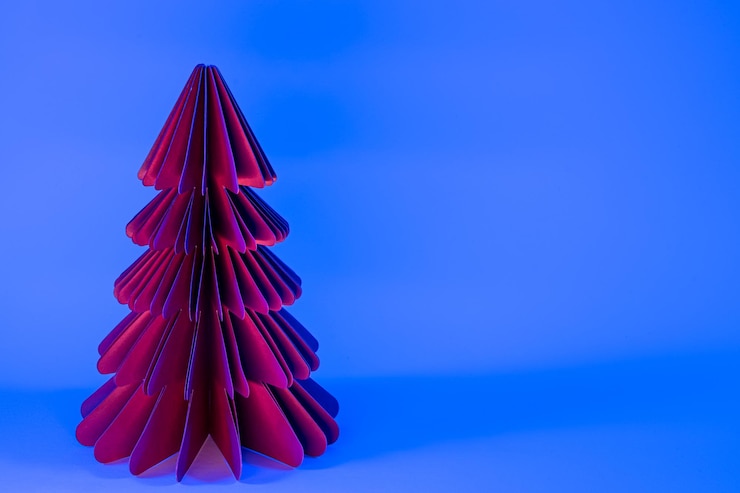 Photo gratuit sapin de noël en papier décoratif sur fond bleu avec néon tendance