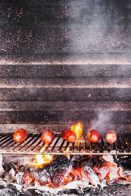 Saucisses sur le grill avec des flammes