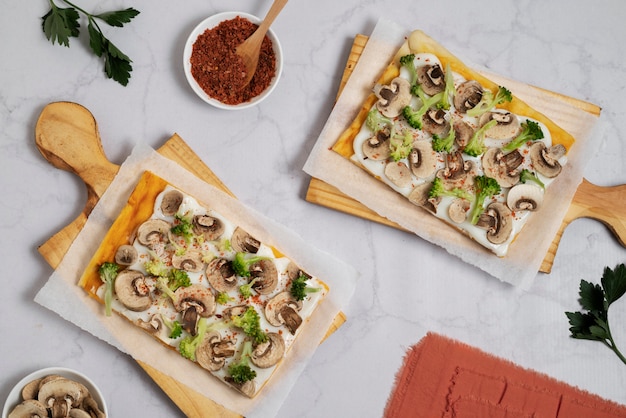 Photo gratuite savoureuses pizzas carrées sur planche de bois