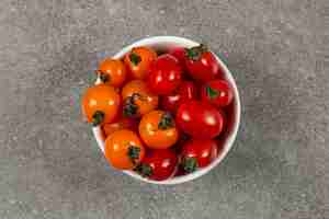 Photo gratuite de savoureuses tomates vertes dans le bol, sur le marbre.