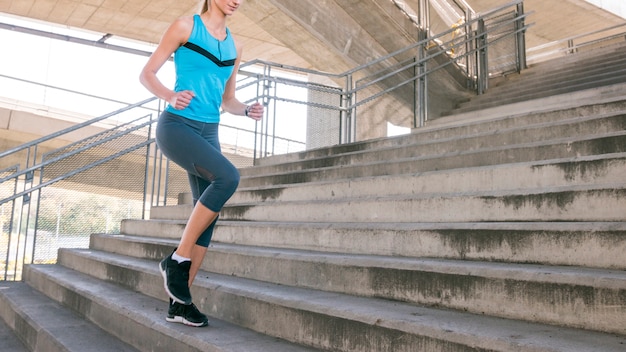 Section basse, de, fitness, jeune femme, jogging, sur, escalier