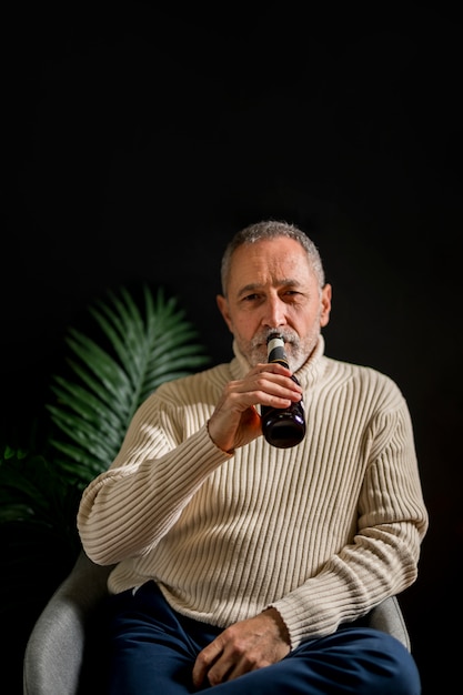 Senior homme buvant de la bière froide