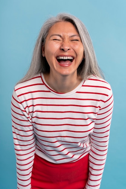 Senior woman rire sur un fond bleu