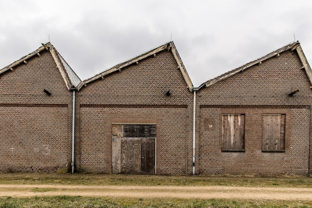 Sentier près d'un bâtiment en brique avec un ciel nuageux dans le