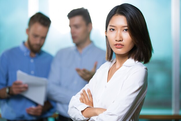 Serious confident Asian lady boss cross arms