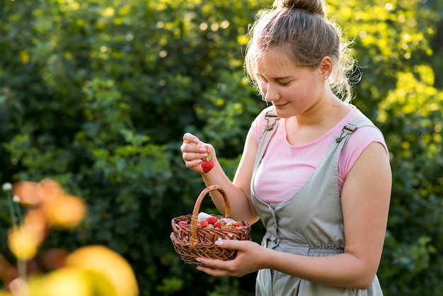 Smiley femme avec panier de fraises