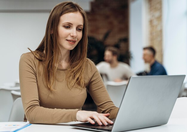 Smiley femme travaillant sur un ordinateur portable