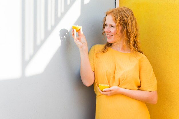 Smiley girl holding lemon