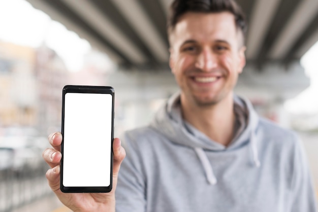 Smiley male holding mobile phone