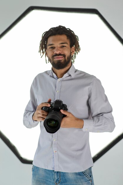 Smiley man holding camera