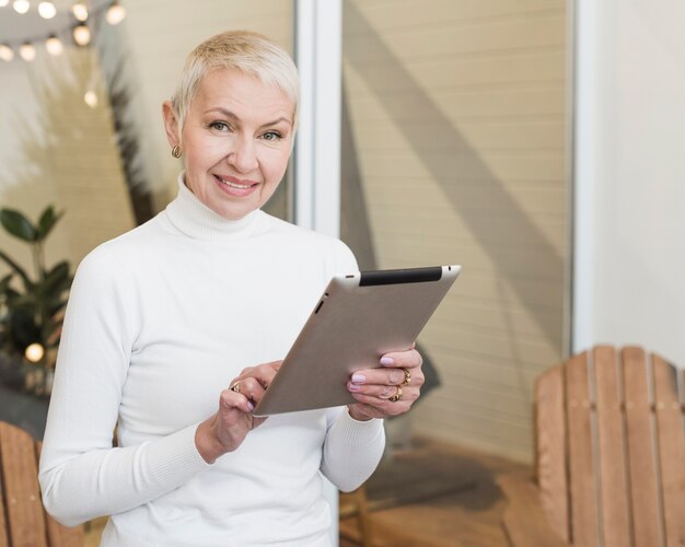 Smiley mature woman using her tablet