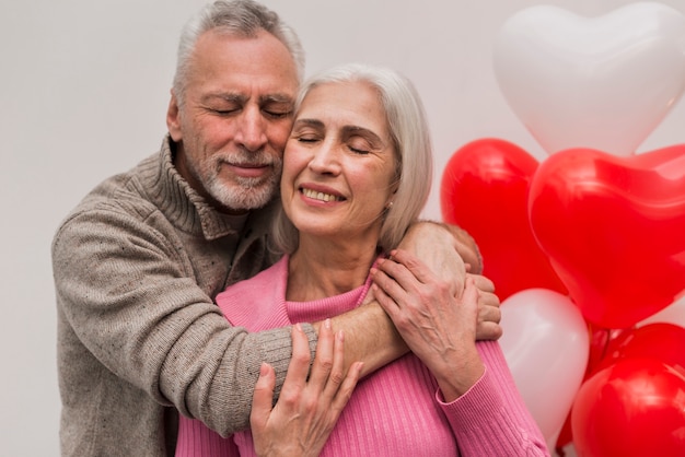 Smiley senior couple hugging