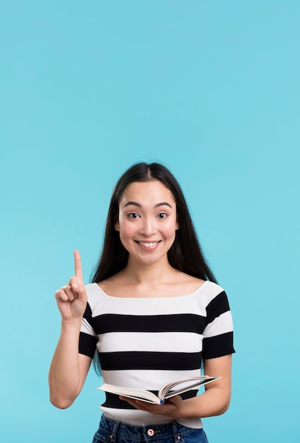 Smiley woman holding book