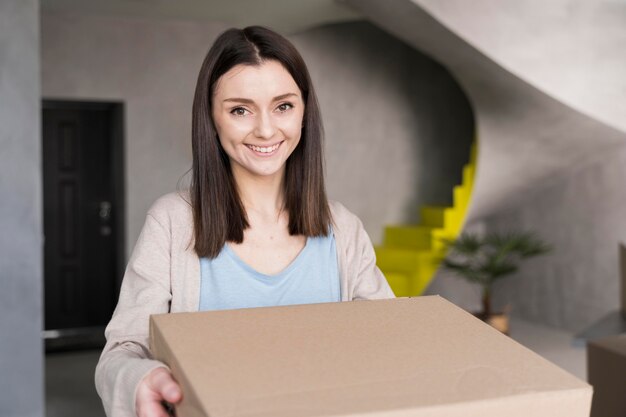 Smiley woman holding box