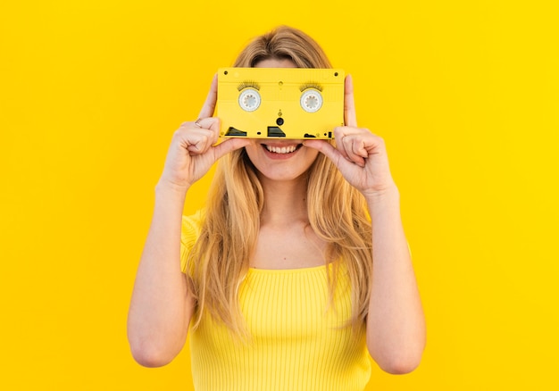 Smiley woman holding cassette