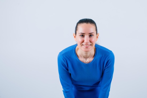 Photo gratuite smling jeune fille regarde la caméra sur fond blanc