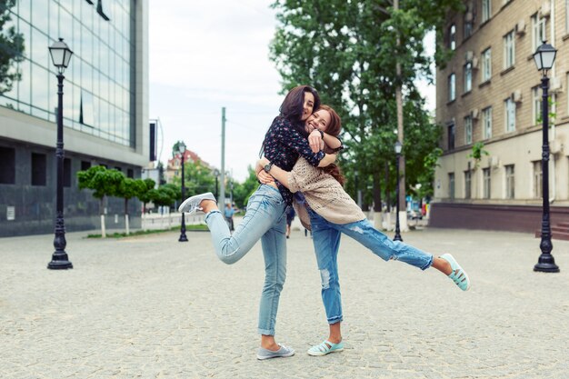 Soeurs souriantes insouciantes étreindre et s'amuser ensemble