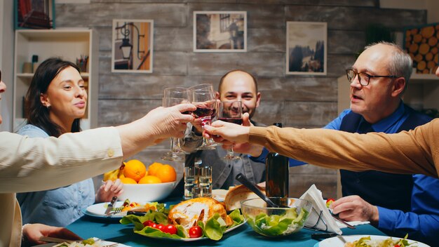 Le soir, la famille s'est réunie pour le dîner en trinquant avec des verres de vin et en portant un toast.