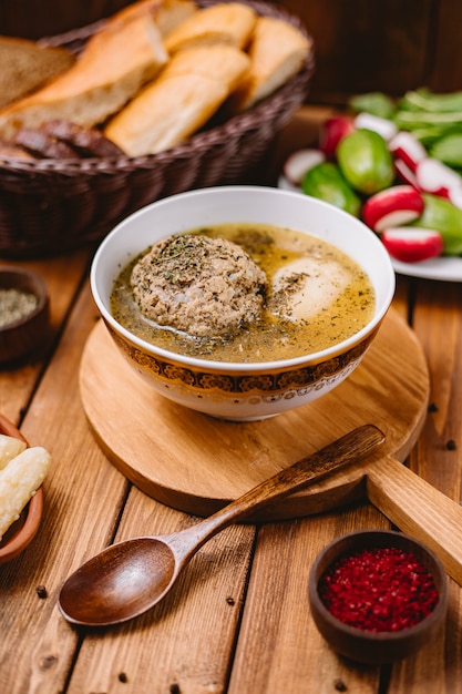 Soupe azerbaïdjanaise aux boulettes de viande kofta garnie de feuilles de menthe séchées